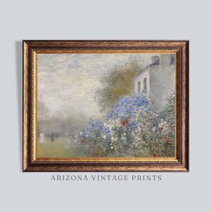 May include: A framed vintage print of a landscape scene. The artwork depicts a white building with blue window frames, surrounded by vibrant blue, red, and white flowers. The frame is a dark, ornate gold color. The text "ARIZONA VINTAGE PRINTS" is at the bottom.