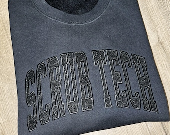 Camiseta o sudadera técnica Scrub con purpurina negra sobre negra