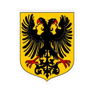 Puede incluir: Una pegatina amarilla con un emblema de águila bicéfala negra con garras y picos rojos. El águila está centrada en un fondo en forma de escudo.