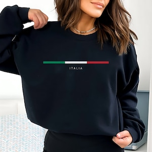 May include: Black sweatshirt with a horizontal Italian flag design and the word "ITALIA" printed below it.