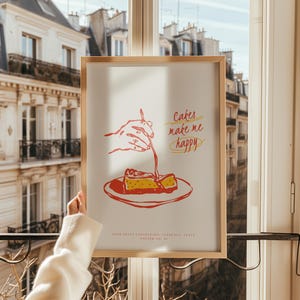 Peut inclure: Une affiche encadrée avec un cadre en bois clair. L'impression présente une illustration rouge et jaune d'un gâteau arrosé de sauce, avec le texte "Cakes make me happy". En dessous de l'image se trouve le texte "FOOD PRINT COLLECTION, FLORENCE, ITALY, POSTER NO. 01."