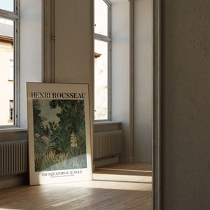 May include: A framed poster of a painting by Henri Rousseau titled "The Equatorial Jungle" featuring a lush green jungle scene with white flowers and a brown animal in the foreground.