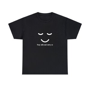 May include: Black t-shirt with a white smiling face and the text "keep calm and carry on".