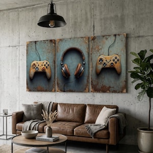 May include: A triptych wall art set featuring a weathered, rusted metal texture background. The left and right panels display vintage-style gaming controllers, while the center panel depicts a pair of over-ear headphones with wired connections.