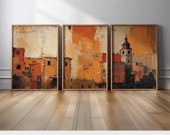May include: Three framed art prints depicting an abstract cityscape in warm tones. The prints, in shades of orange, brown, and beige, are displayed on a wooden floor. The text "PRINTED AND SHIPPED" is visible at the bottom of the image.