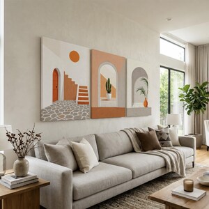 May include: A triptych wall art set featuring three panels with abstract architectural scenes in warm earth tones. The artwork displays arched doorways, a staircase, a sun, a potted cactus, and a palm plant, rendered in shades of orange, beige, and gray.