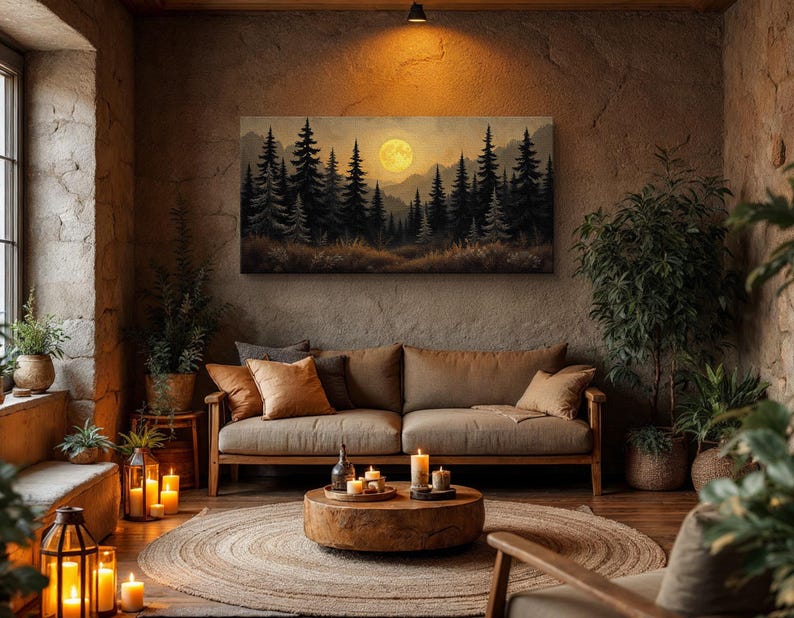 May include: A living room interior with a brown leather sofa, a wooden coffee table, and a large canvas print of a moonlit forest scene. The room is decorated with candles and plants.