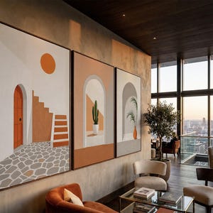 May include: A triptych of framed wall art featuring architectural scenes in warm earth tones. The panels display a white building with an orange door, a staircase, a cactus in a white pot within an archway, and a potted plant in a gray archway.