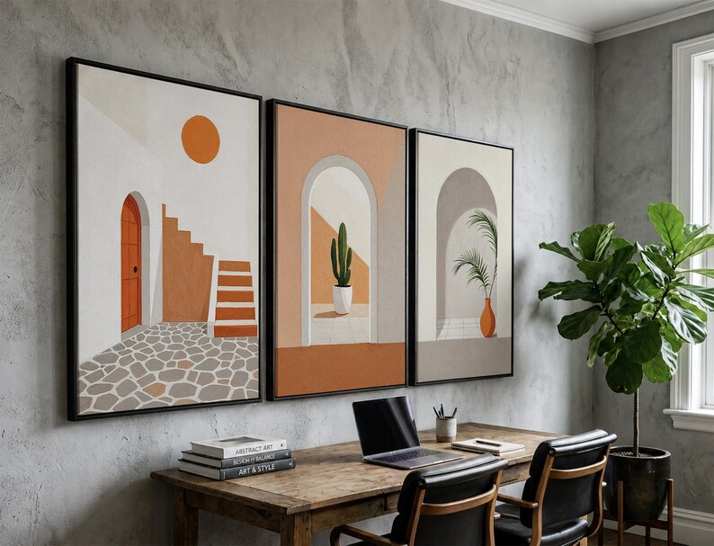 May include: A set of three framed wall art prints featuring architectural scenes with arched doorways, a cactus in a white pot, a palm plant in an orange vase, stone flooring, and a bright orange sun against a neutral background.