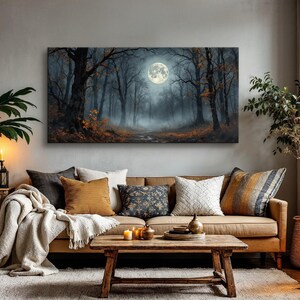 May include: A brown leather sofa with a variety of throw pillows, a throw blanket, and a wooden coffee table. A framed canvas print of a moonlit forest hangs on the wall above the sofa.