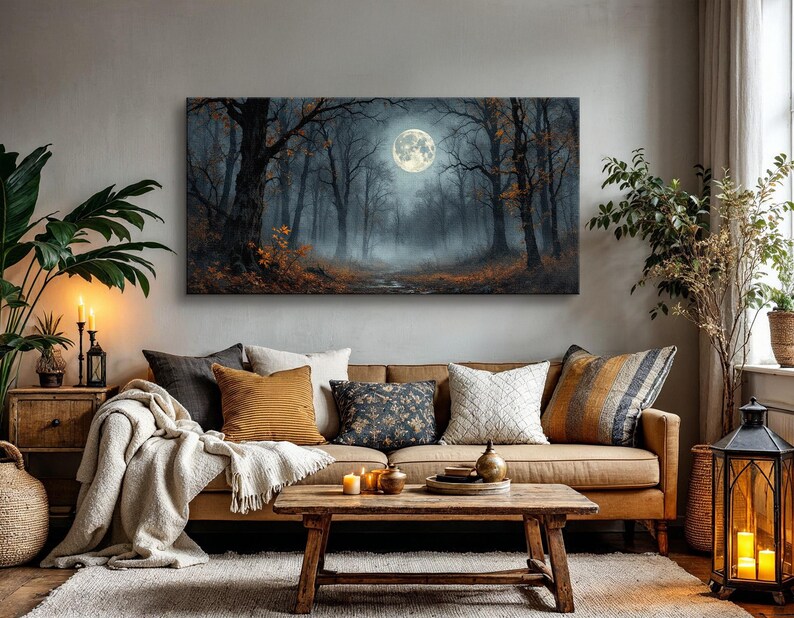 May include: A brown leather sofa with a variety of throw pillows, a throw blanket, and a wooden coffee table. A framed canvas print of a moonlit forest hangs on the wall above the sofa.