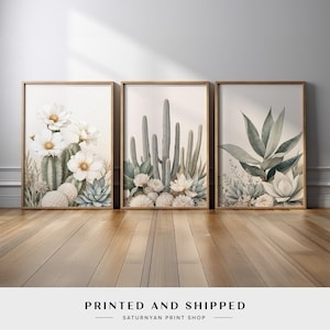 May include: Three framed botanical prints featuring watercolor illustrations of cacti and succulents. The prints showcase a variety of desert plants with white flowers and muted green and beige tones. The text "PRINTED AND SHIPPED" is at the bottom.