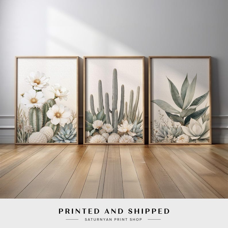 May include: Three framed botanical prints featuring watercolor illustrations of cacti and succulents. The prints showcase a variety of desert plants with white flowers and muted green and beige tones. The text "PRINTED AND SHIPPED" is at the bottom.