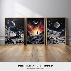 May include: Three framed prints of a lone astronaut in a space suit standing on a moon-like landscape with a starry sky and planets in the background. The astronaut is looking up at the sky in the middle print, sitting down in the left print, and walking towards a bright light in the right print.