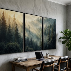 May include: A triptych wall art set featuring a dense coniferous forest landscape with tall pine trees shrouded in morning mist and golden sunlight rays filtering through the branches, framed in thin black borders on a textured gray wall.