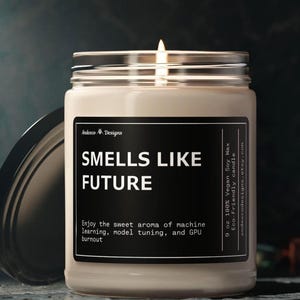 May include: A 9 ounce soy wax candle in a clear glass jar with a black label that reads "Smells Like Future". The label also includes the text "Enjoy the sweet aroma of machine learning, model tuning, and GPU burnout".