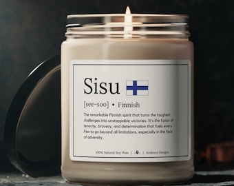 May include: A beige candle with a glass jar and a white label. The label has the word "Sisu" in bold black font, the phonetic pronunciation "[see-soo]" in smaller black font, and the word "Finnish" in black font. The label also includes a small image of the Finnish flag. The text on the label reads: "The remarkable Finnish spirit that turns the toughest challenges into unstoppable victories. It's the fusion of tenacity, bravery, and determination that fuels every Finn to go beyond all limitations, especially in the face of adversity. 100% Natural Soy Wax | Andesco Designs"