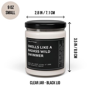May include: A 9 ounce soy wax candle in a clear glass jar with a black lid. The candle is labeled "Smells Like a Badass Wild Swimmer". The jar is 2.8 inches in diameter and 3.5 inches tall.