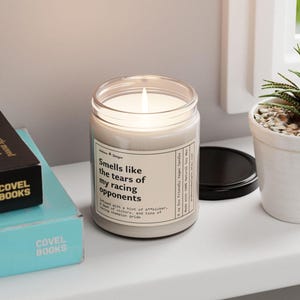 a funny candle that says smells like the tears of my racing opponents - infused with a hint of A**kicker, a dash of victory, and tons of racing champion pride.