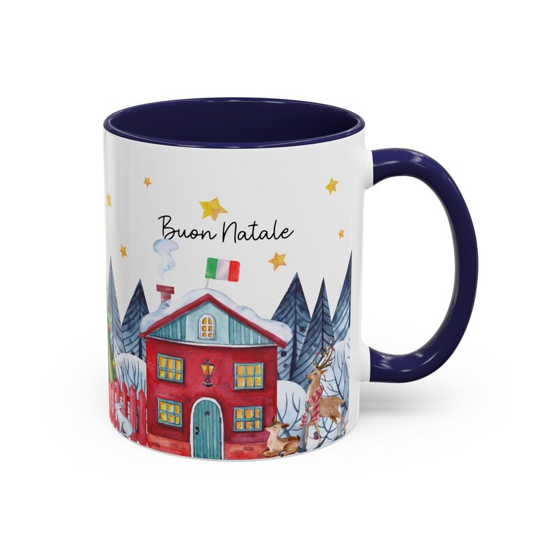 May include: White ceramic mug with a blue rim and handle. The mug features a watercolor illustration of a red house with a green roof and white trim, surrounded by trees and snow. The text "Buon Natale" is printed on the mug in black.