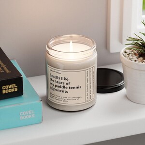 a funny paddle tennis candle  that says smells like the tears of my paddle tennis opponents - Infused with a hint of A**kicker, a dash of victory, and tons of court champion glory