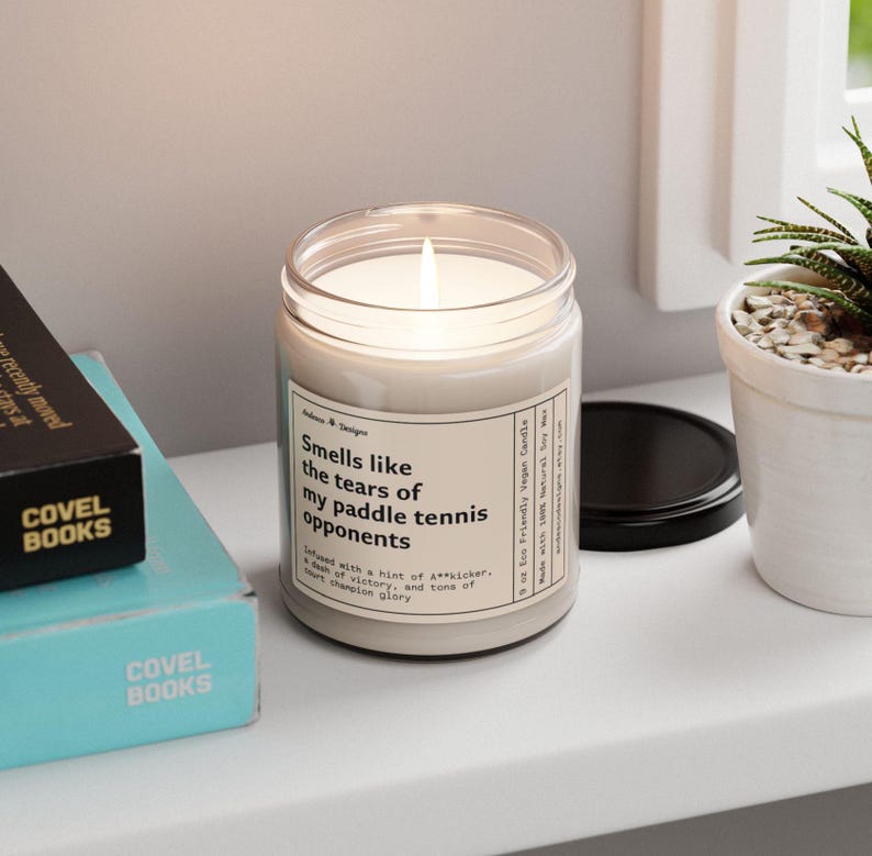 a funny paddle tennis candle  that says smells like the tears of my paddle tennis opponents - Infused with a hint of A**kicker, a dash of victory, and tons of court champion glory