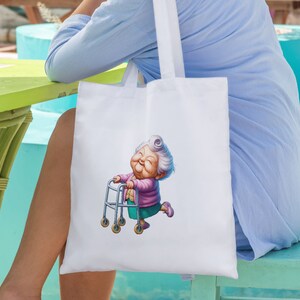 May include: White tote bag featuring a cartoon illustration of a woman with grey hair pushing a walking frame. The woman is smiling and wearing a purple shirt and green trousers.