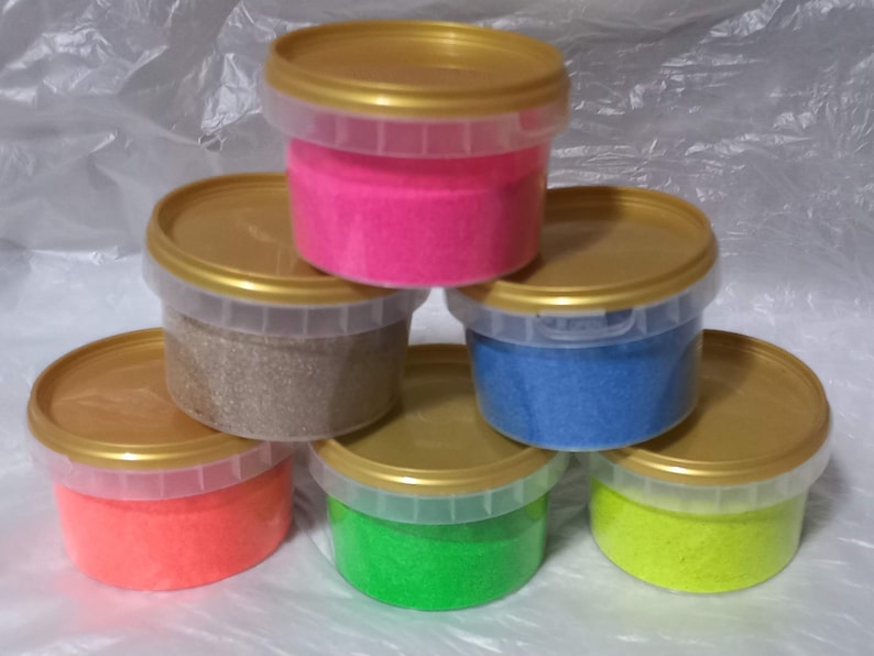 May include: Six containers of colorful glitter, each in a clear plastic container with a gold lid. The colors are pink, brown, blue, orange, green, and yellow.