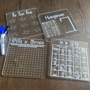 Fun acrylic travel games.  Set of 4.  Eye Spy, Hangman, Tic Tac Toe, Dots and Boxes. 2 pens and travel bag.