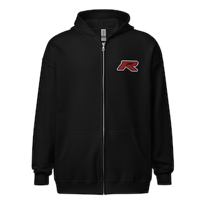 Könnte beinhalten: Schwarzer Kapuzenpullover mit Reißverschluss, Kapuze und Vordertaschen. Der Hoodie hat ein rot-weißes stilisiertes "R"-Logo auf der linken Brust. Der Reißverschluss ist silberfarben.