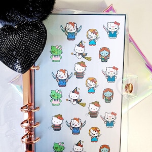 May include: A sheet of stickers featuring Hello Kitty dressed as various horror movie characters. The stickers are colorful and feature characters like Freddy Krueger, Jason Voorhees, and Michael Myers.