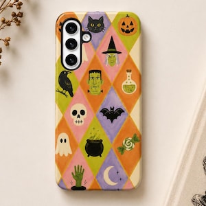 May include: A rectangular phone case featuring a colorful argyle pattern of diamonds in shades of orange, yellow, purple, and cream. Each diamond contains a Halloween-themed illustration, including a black cat, pumpkin, witch, raven, skull, bat, ghost, cauldron, potion bottle, candy, green hand, and crescent moon.