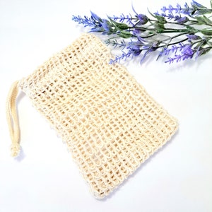 May include: A beige, mesh, drawstring bag made of natural fibers. The bag is empty and has a textured surface.