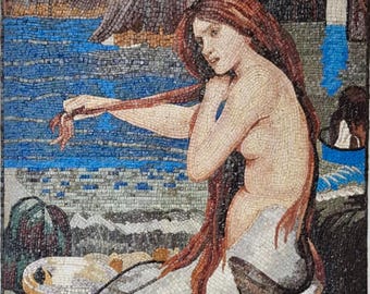 May include: Mosaic artwork depicting a mermaid with long red hair, seated near the ocean. The mosaic is composed of small, colorful tiles, creating a detailed image of the mermaid, rocks, and water. The background features cliffs and a cave.
