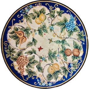 May include: Round mosaic table top with a detailed fruit and floral design. The mosaic features grapes, figs, pears, and other fruits, along with green leaves and blue flowers. The border is a deep blue with a gold trim.