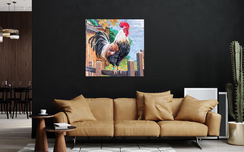 May include: A colorful painting of a rooster standing on a fence. The rooster is black, white, and red with a large red comb. The background is a blurred image of a farm scene.