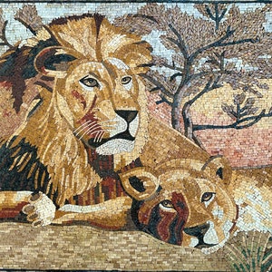 May include: A mosaic artwork depicting a pair of lions, one male and one female, in a desert setting. The male lion is in the foreground, with its head turned to the side, while the female lion is behind it, looking directly at the viewer. The artwork is made up of small, colorful tiles, creating a textured and detailed image.