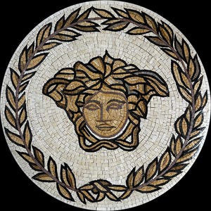 May include: Circular mosaic depicting a Medusa head in brown and gold tones, framed by a laurel wreath. The mosaic is set against a white background, with a black border. The design is detailed, showcasing a classic, elegant style, suitable for home decor.