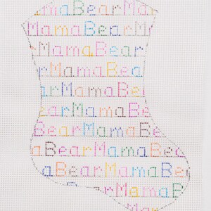 May include: A white canvas with a black outline of a stocking filled with the words "Mama Bear" repeated in different colors.