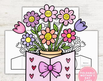 May include: A printable Mother's Day card with a pop-up design. The card features a vase with flowers and a bow. The flowers have different colored petals and centers. The card is decorated with hearts and the text "I love you, Mom."  "You are my light." "You are special." "You are my joy."