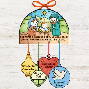 May include: A Christmas decoration depicting a nativity scene with Mary, Joseph, and baby Jesus. The ornament includes the text "For to us a child is born..." and decorative pendants with religious titles. It is topped with an orange bow.