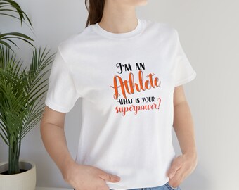 May include: White t-shirt with the text "I'm an Athlete. What is your superpower?" in black and orange lettering.