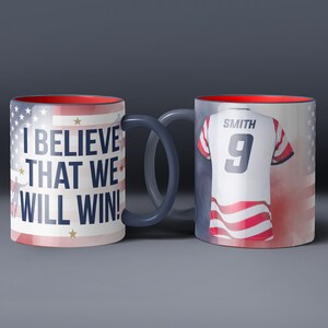 May include: Two ceramic mugs with patriotic designs. One mug features the text "I BELIEVE THAT WE WILL WIN!" and the American flag. The other mug displays a jersey with the name "SMITH" and the number "9". Both mugs have red interiors.