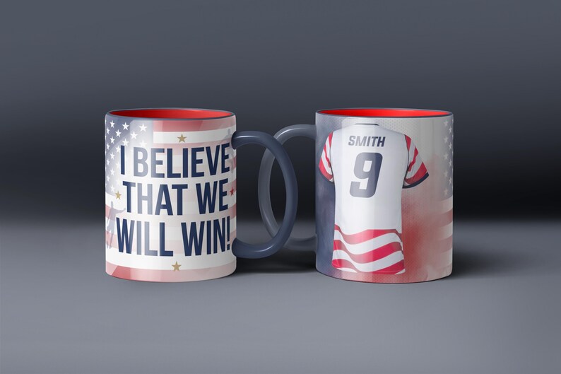 May include: Two ceramic mugs with patriotic designs. One mug features the text "I BELIEVE THAT WE WILL WIN!" and the American flag. The other mug displays a jersey with the name "SMITH" and the number "9". Both mugs have red interiors.