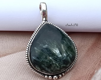 May include: A silver pendant featuring a teardrop-shaped green stone. The stone has a swirling pattern of white and green.