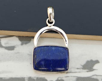 May include: A silver pendant with a rectangular lapis lazuli stone. The pendant is in the shape of a small archway.