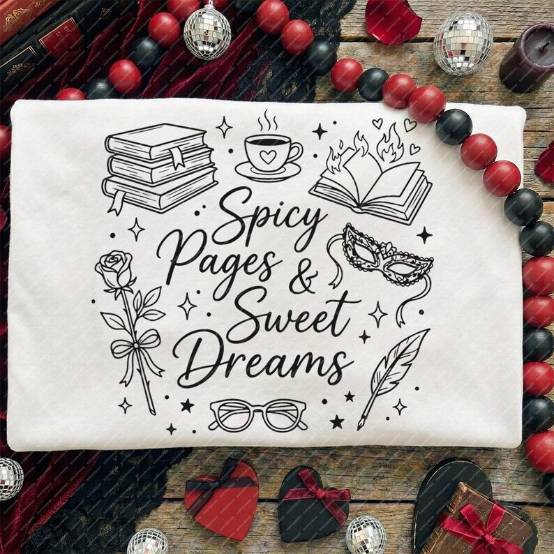 May include: White t-shirt with a black graphic design featuring books, a cup of coffee, a rose, and the text "Spicy Pages & Sweet Dreams." The design includes a burning book, a masquerade mask, glasses, and a feather.