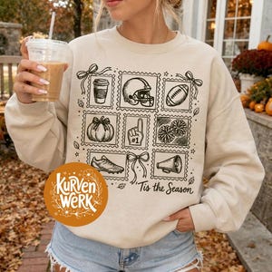 May include: A beige crewneck sweatshirt featuring a black graphic print of various fall and football-themed icons arranged in a grid of postage stamp-style frames, including a coffee cup, helmet, football, pumpkin, foam finger, and megaphone.