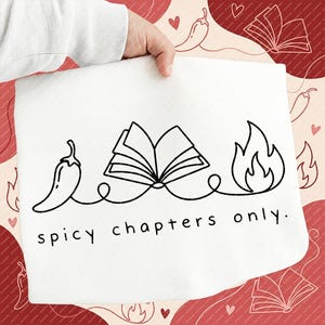 May include: White kitchen towel with a black line drawing of a chili pepper, an open book, and flames, connected by a curved line. The text "spicy chapters only" is below the drawing.