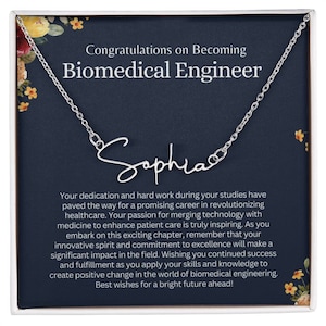 May include: A silver necklace with the name "Sophia" inscribed on it, presented in a blue gift box with a floral design and a congratulatory message for a new biomedical engineer.
